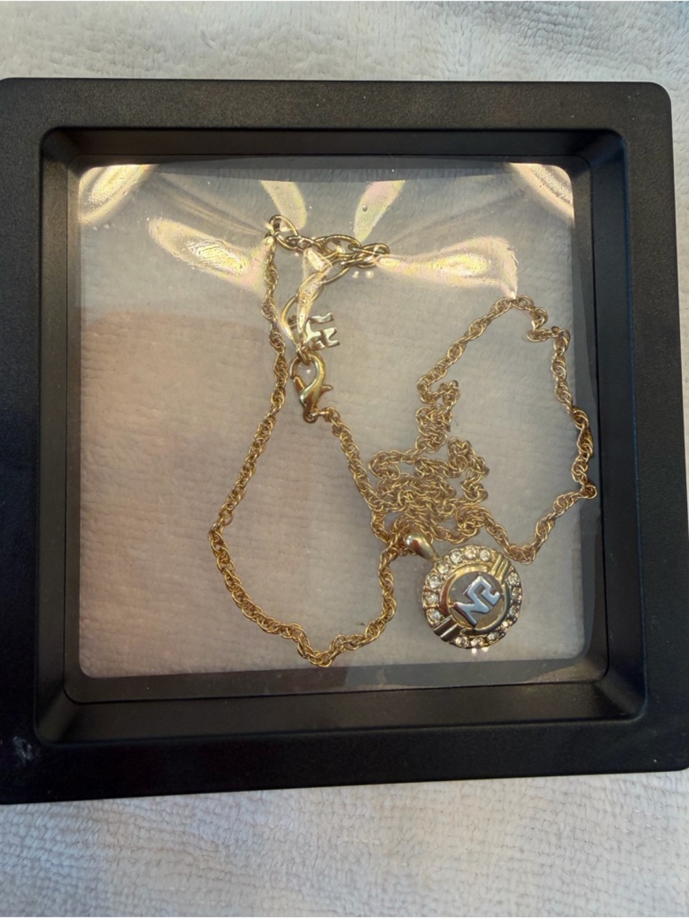 Nina Ricci Gold Logo Medallion Necklace with Crystal Halo